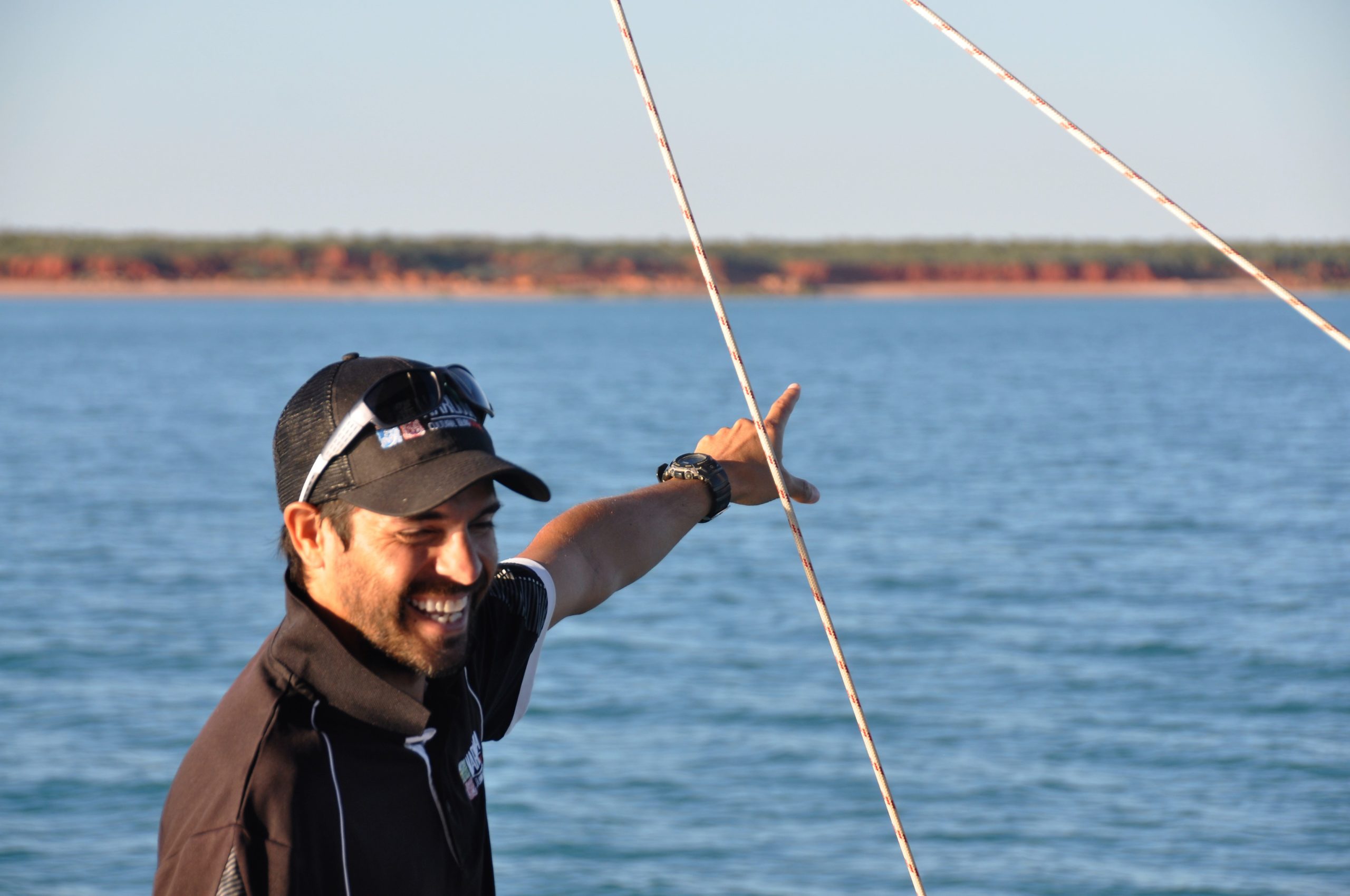 a man standing next to a body of water