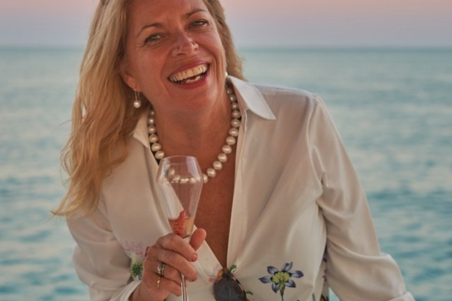 a woman standing next to a body of water