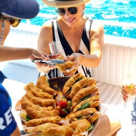 a woman sitting at a table with food