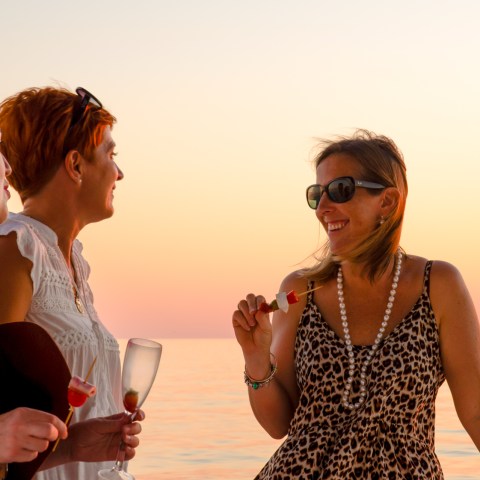 a woman drinking water from a beach